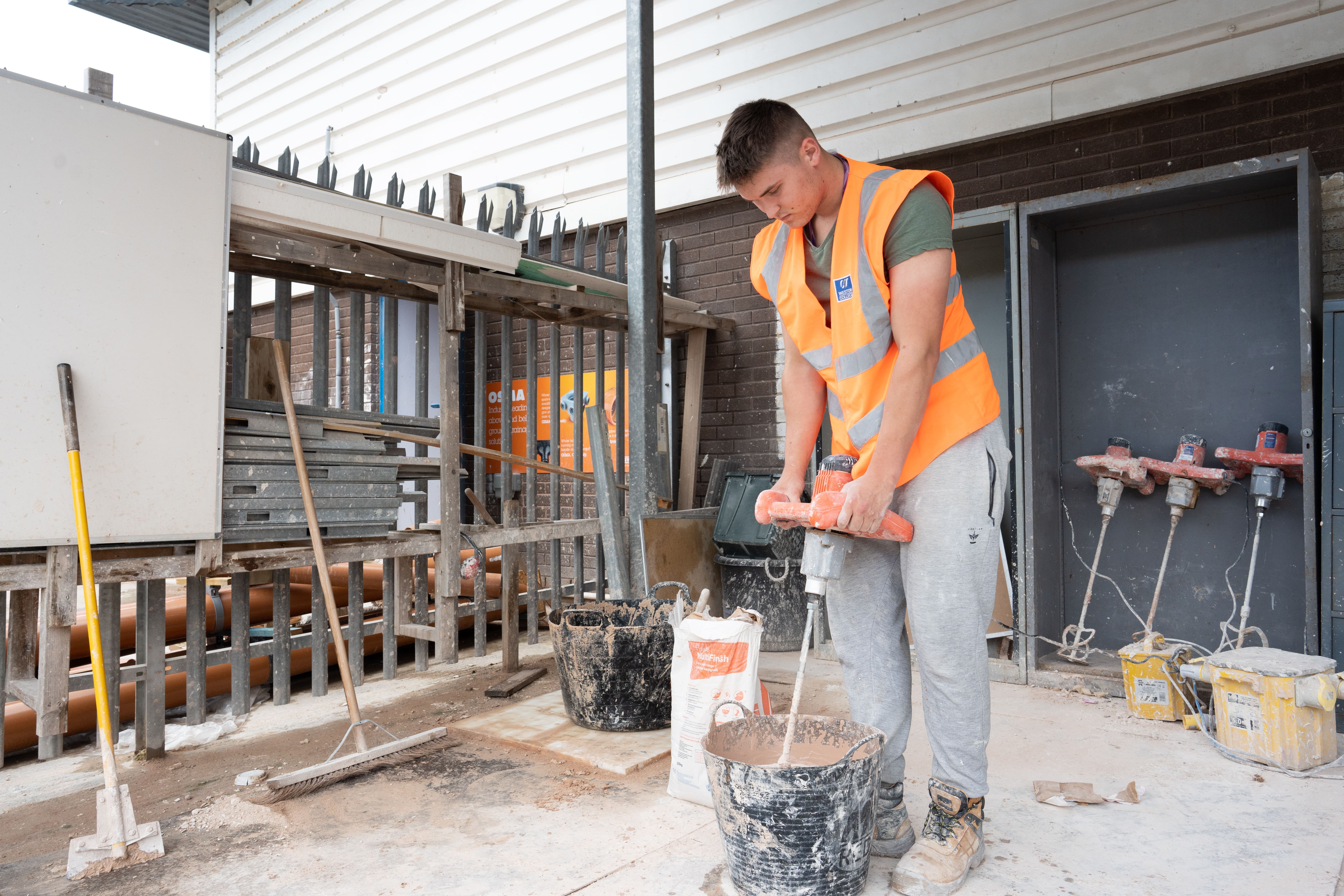 A student mixing plaster