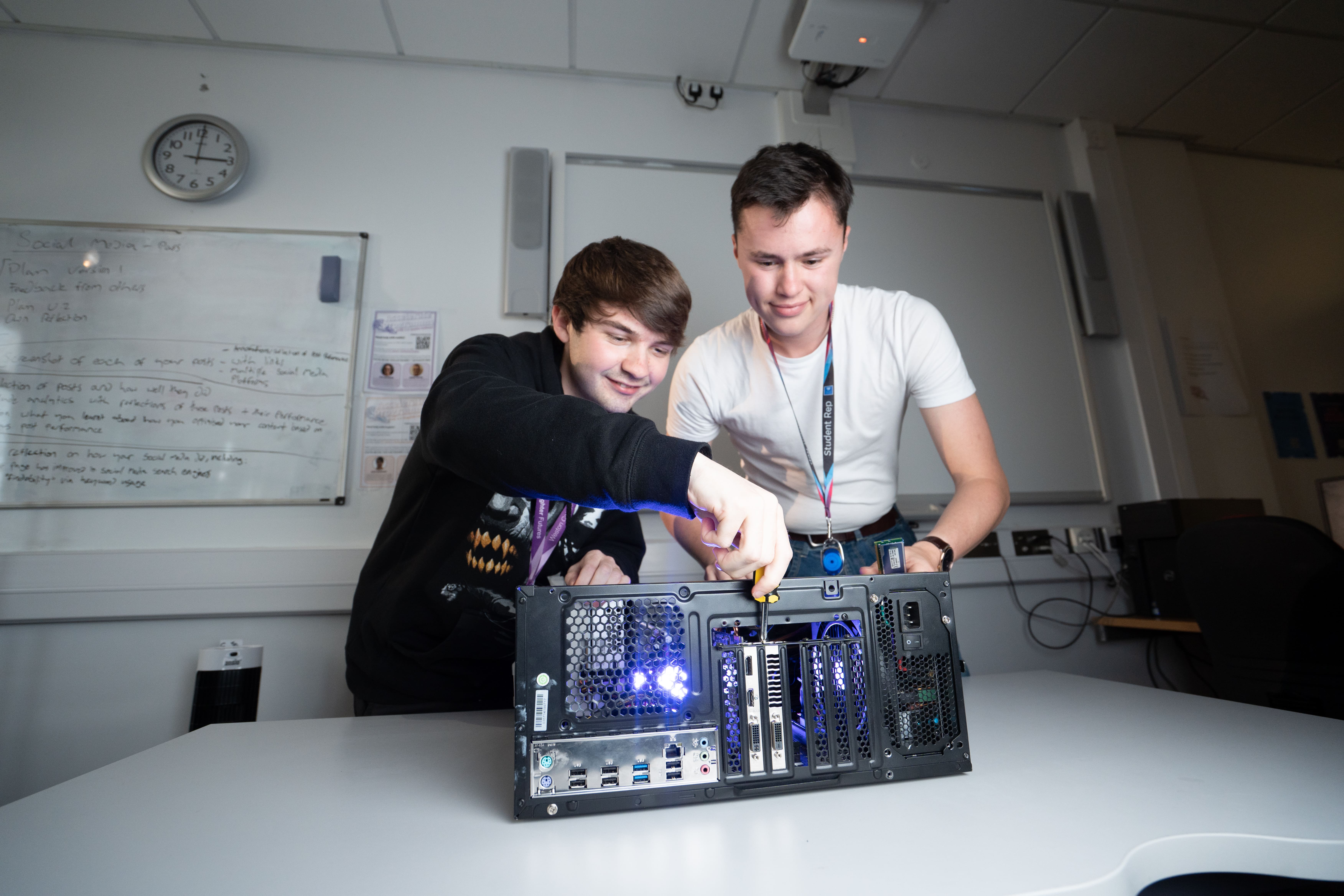 two students fixing a PC