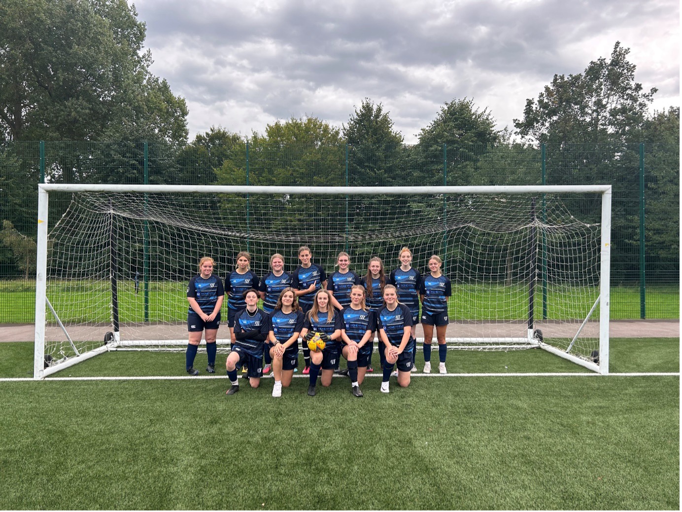 Weston sport girls football team picture on pitch in front of goal