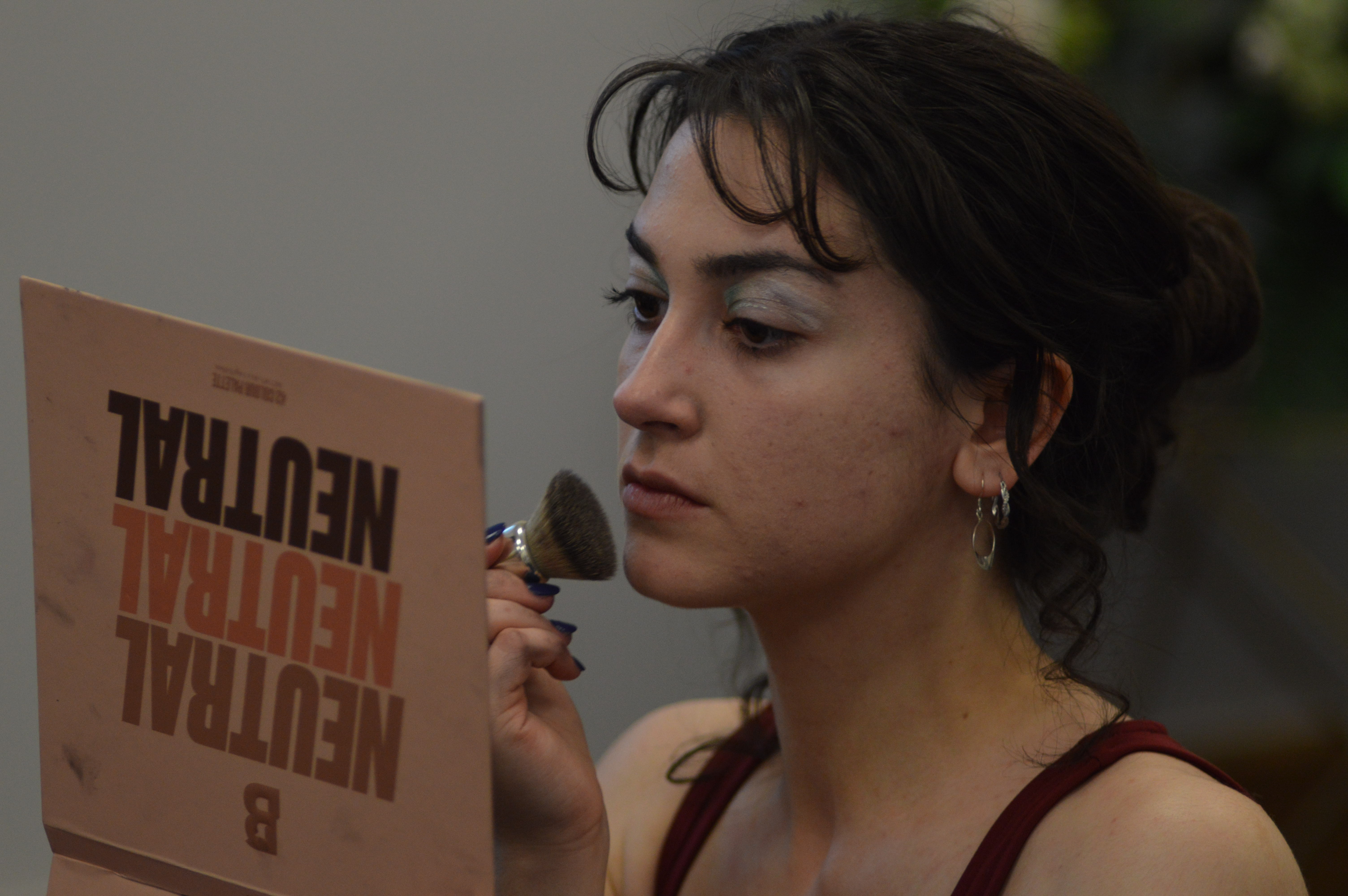 Student applying their makeup