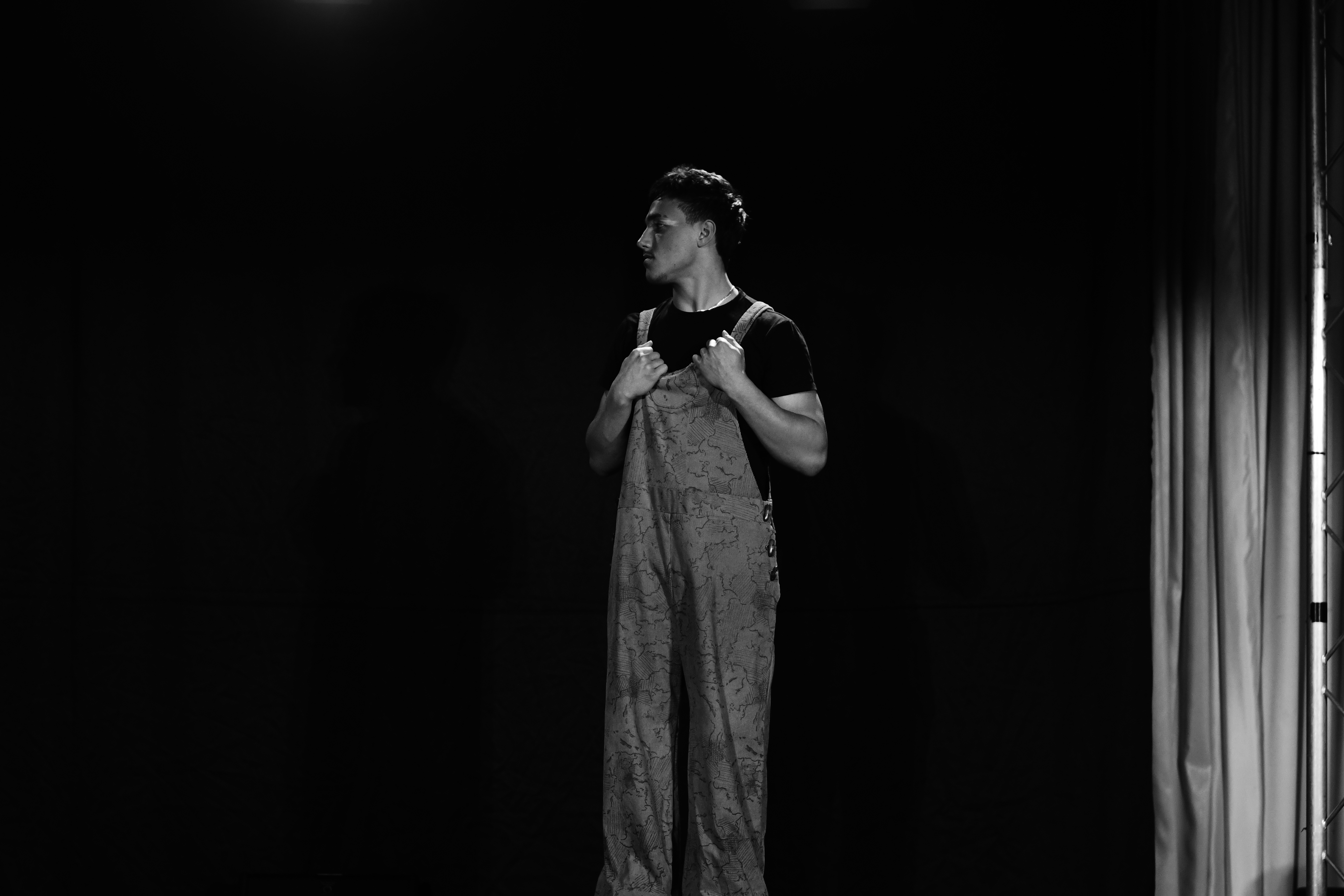 Black and white photo of model in dungarees
