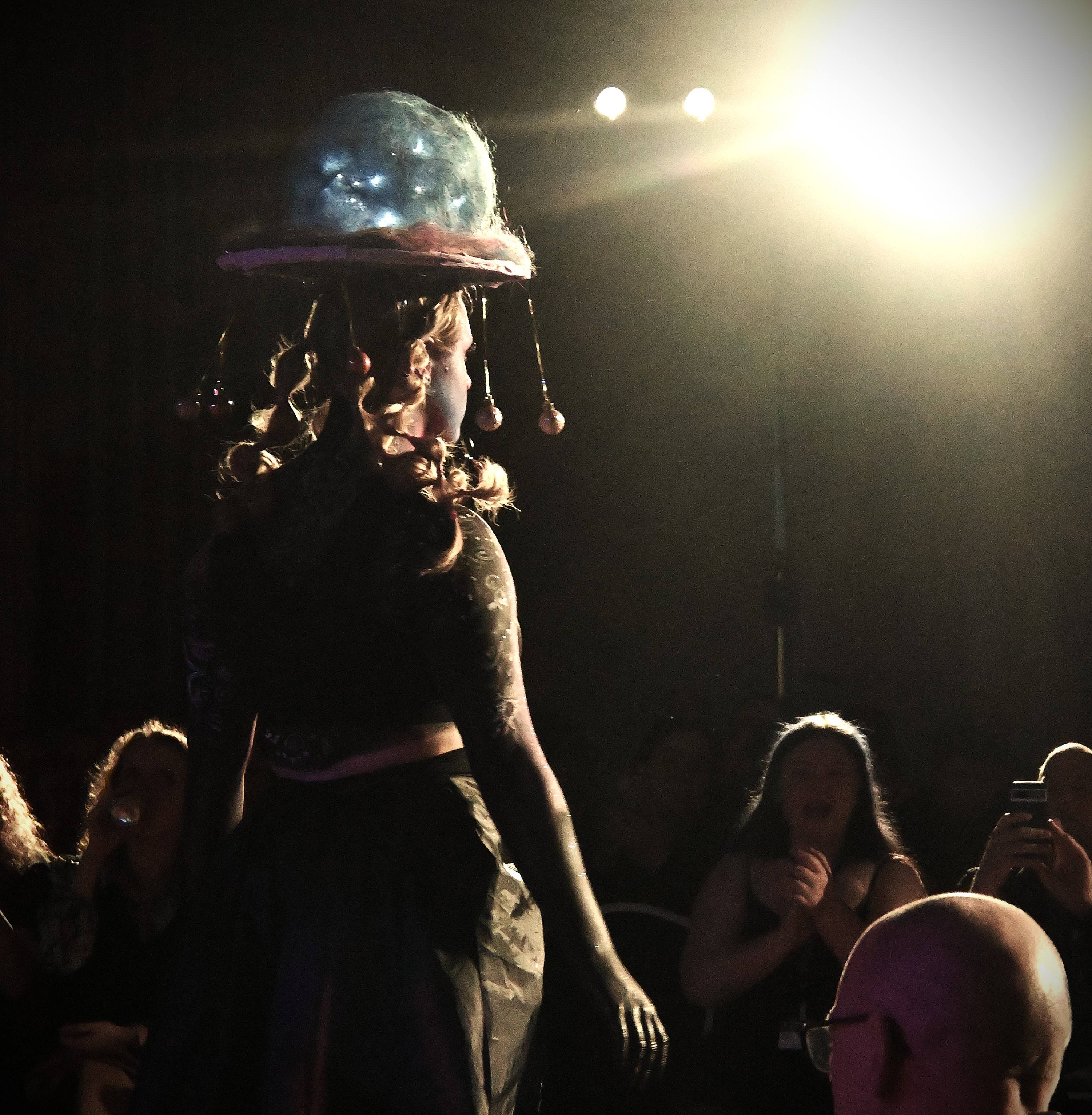 One of the models facing away from the camera wearing galaxy-themed headwear