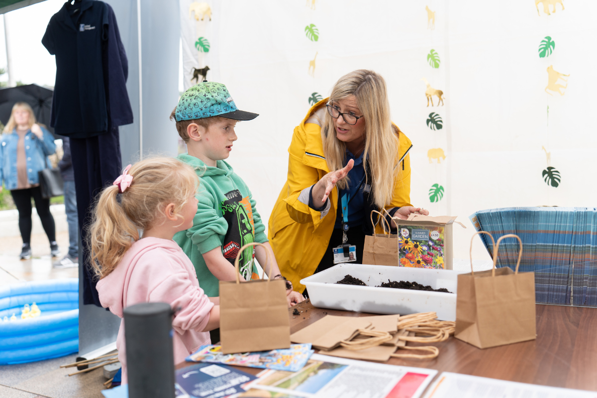 Children creating bee flower bombs with animal management