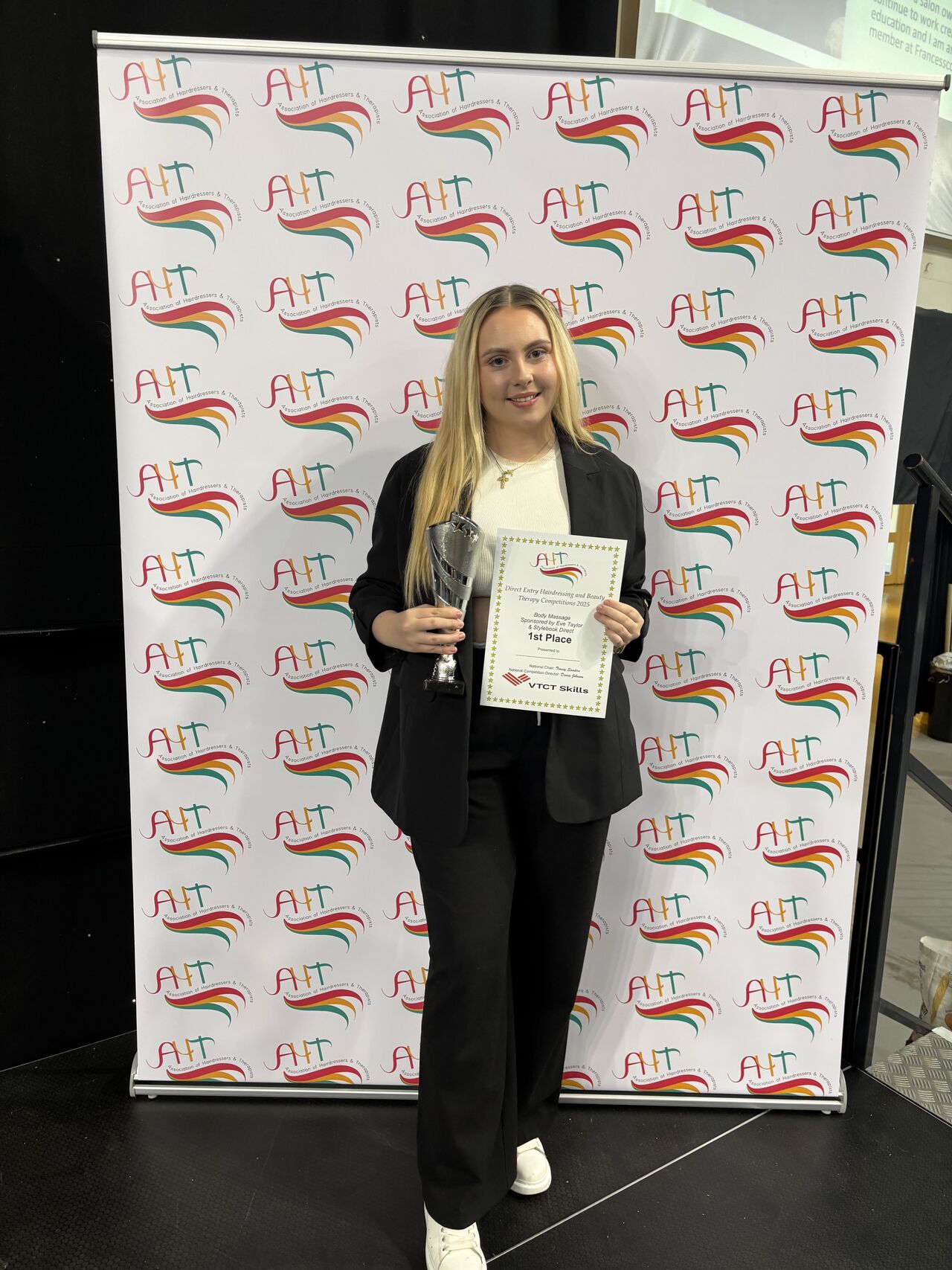 Student holding her award and certificate