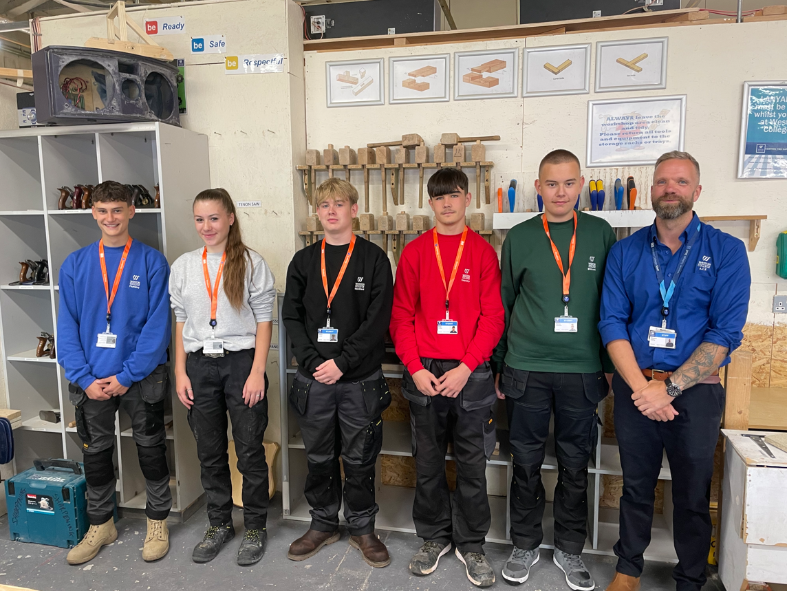Construction students showing off their new uniforms