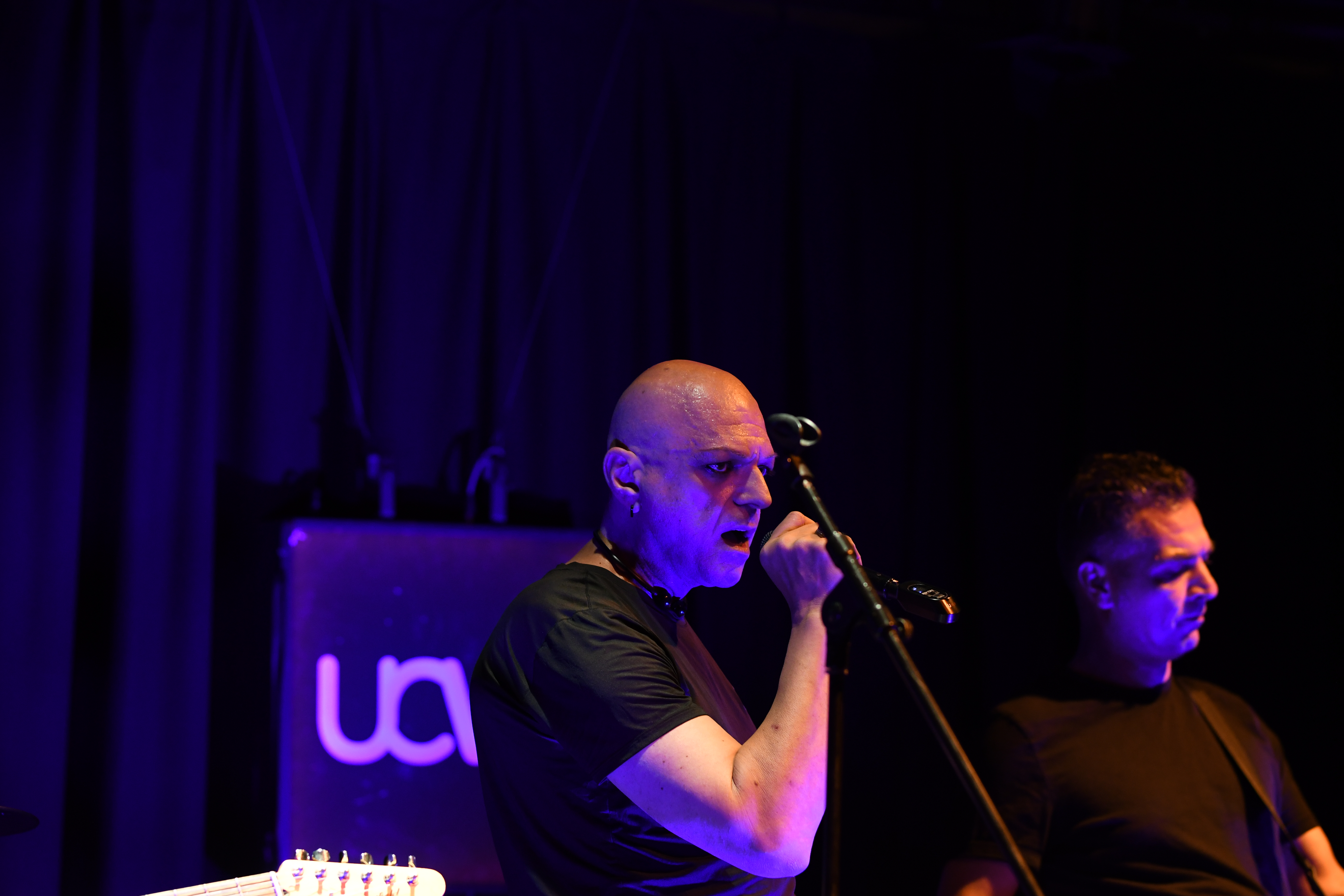 The Peripheries Lead Singer singing on stage