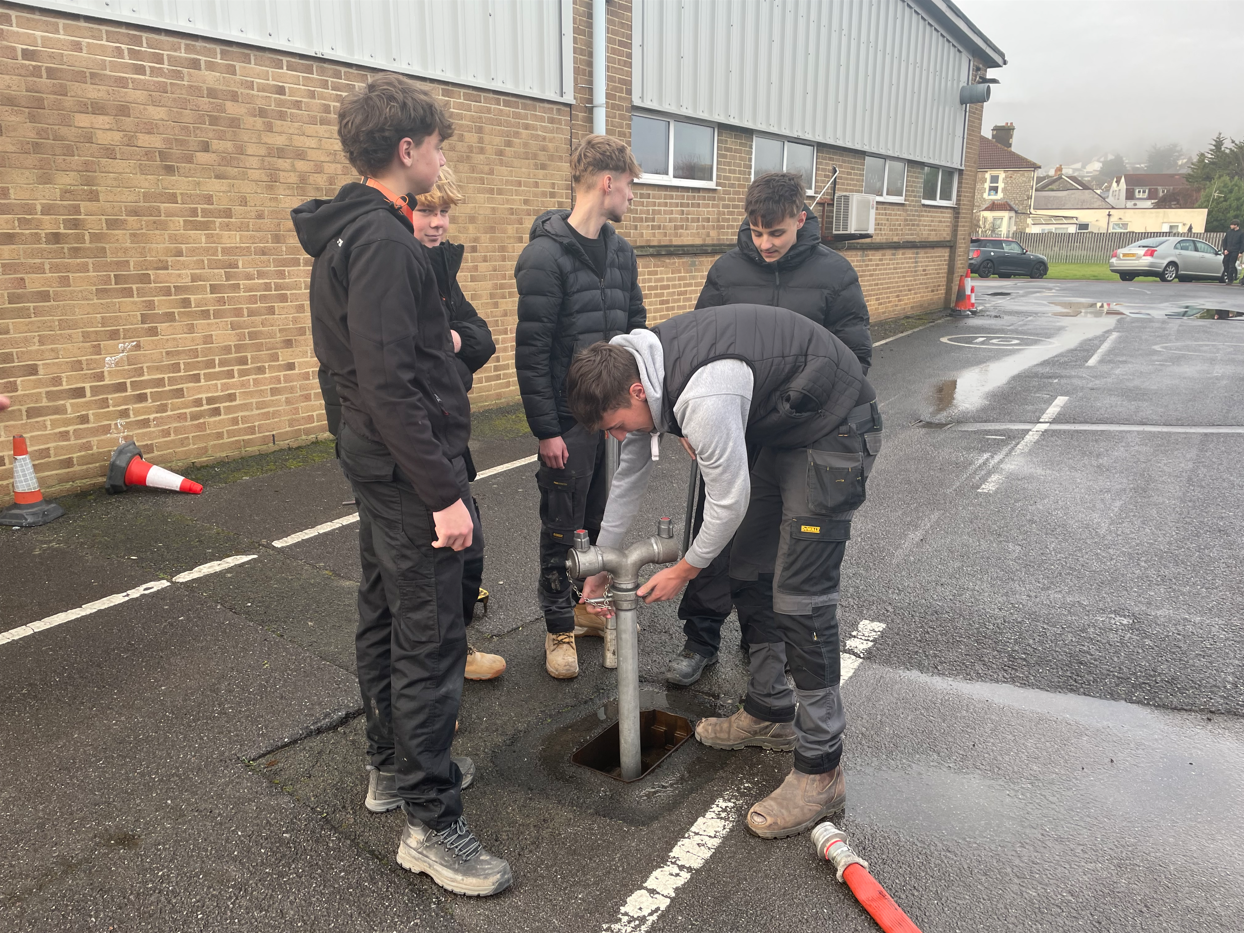 students tapping into fire hydrant water