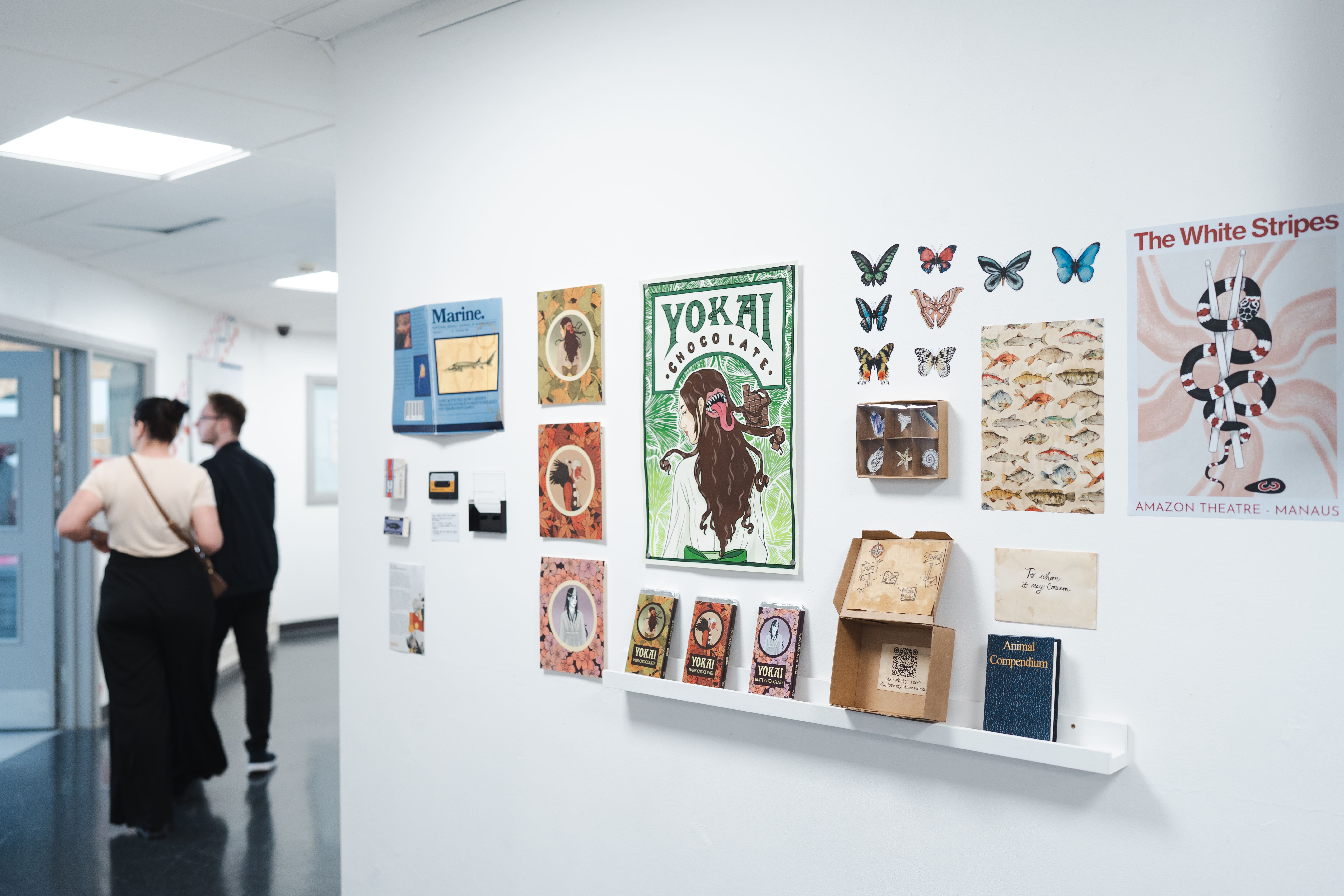 multiple pieces of art on a wall