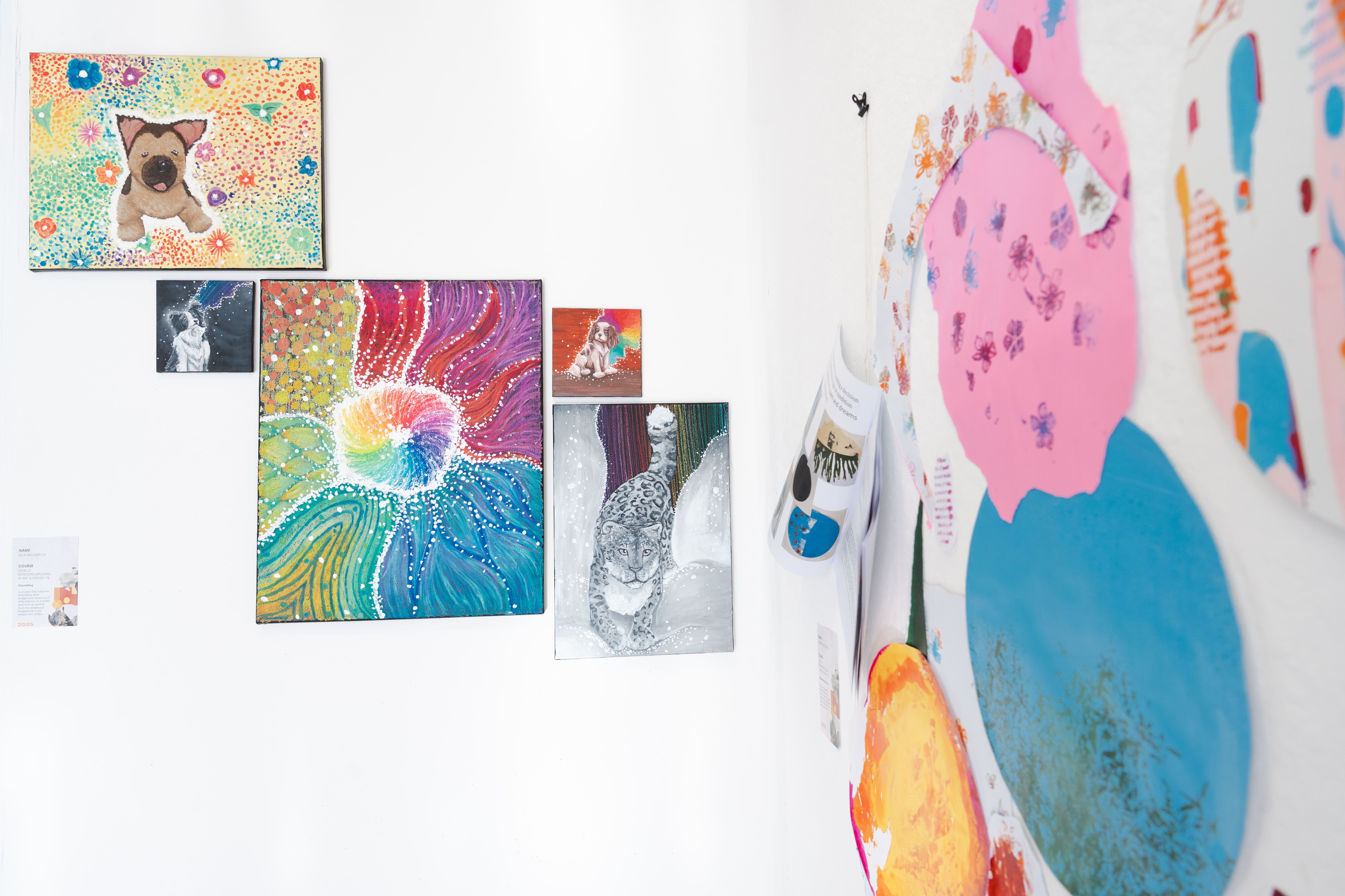 multiple pieces of art on a wall