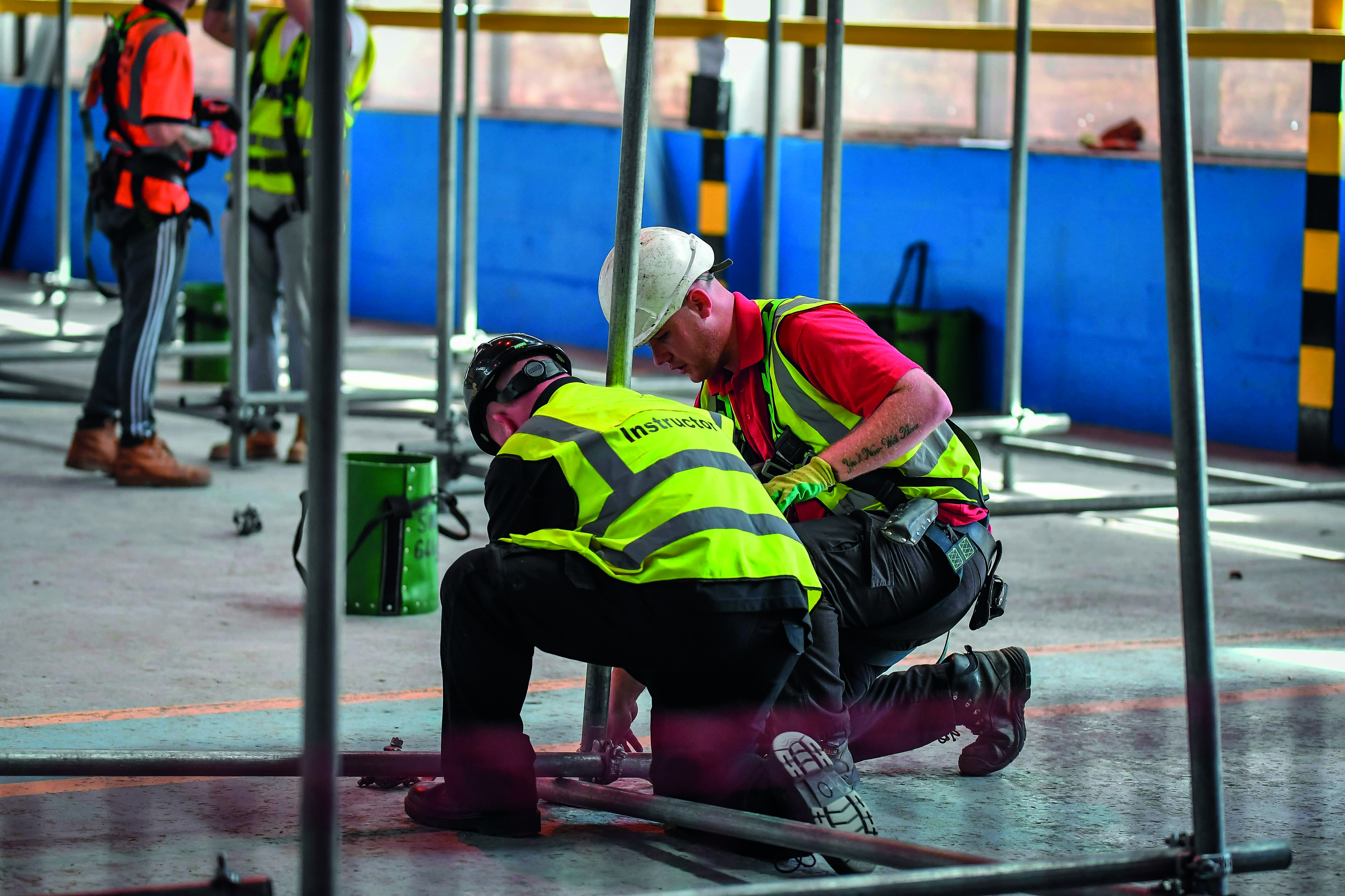 Instructor teaching scaffolding to student
