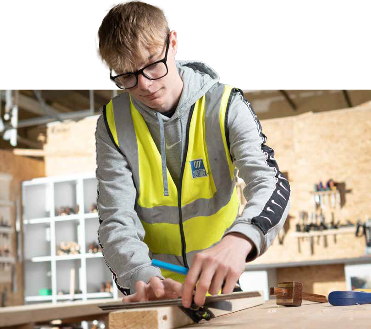 a male student doing some woodwork
