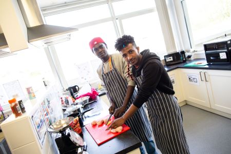 Two learners chopping up chicken