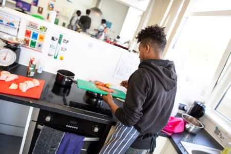 Learner putting mince into the pan