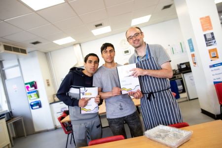 Learners showcasing their cookbook