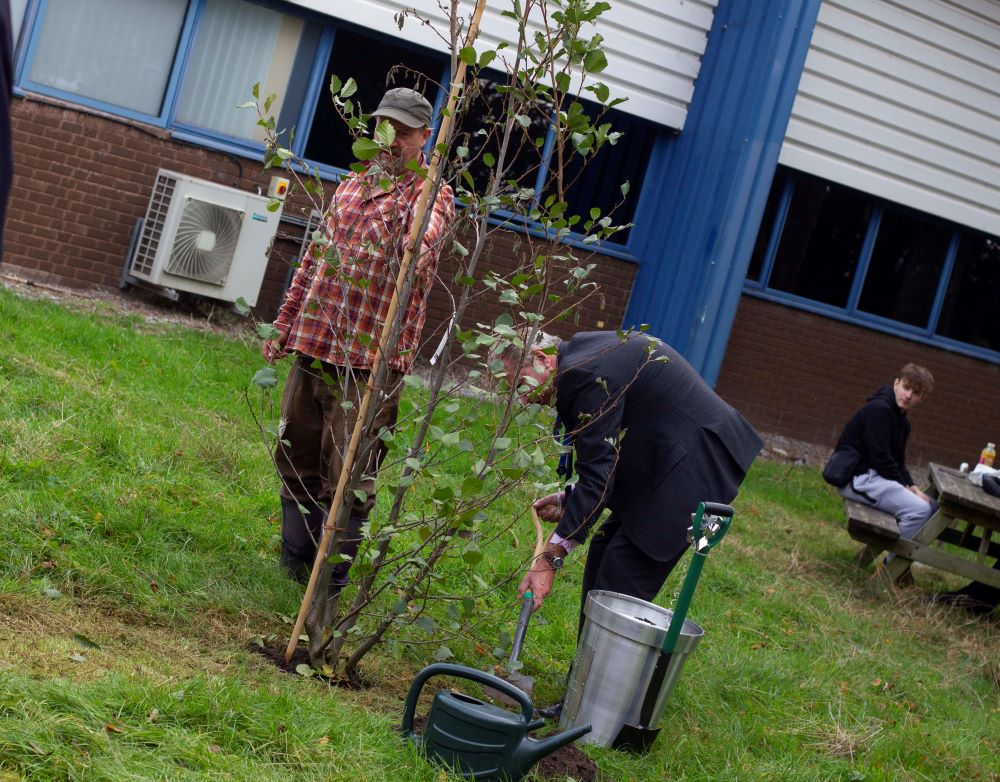 Sir Paul Phillips planting the tree