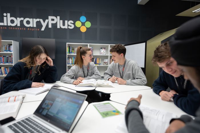 learners engaging in conversation at the library