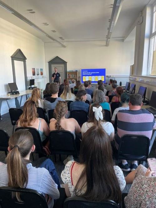 Luke delivering a talk to students about careers