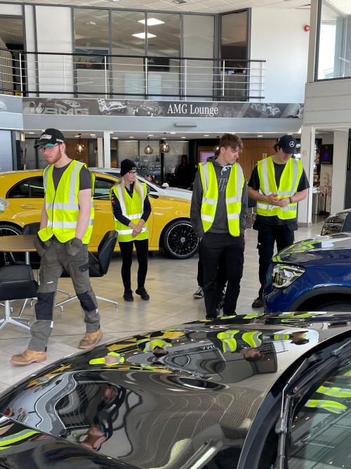 Motor Vehicle learners exploring car showroom