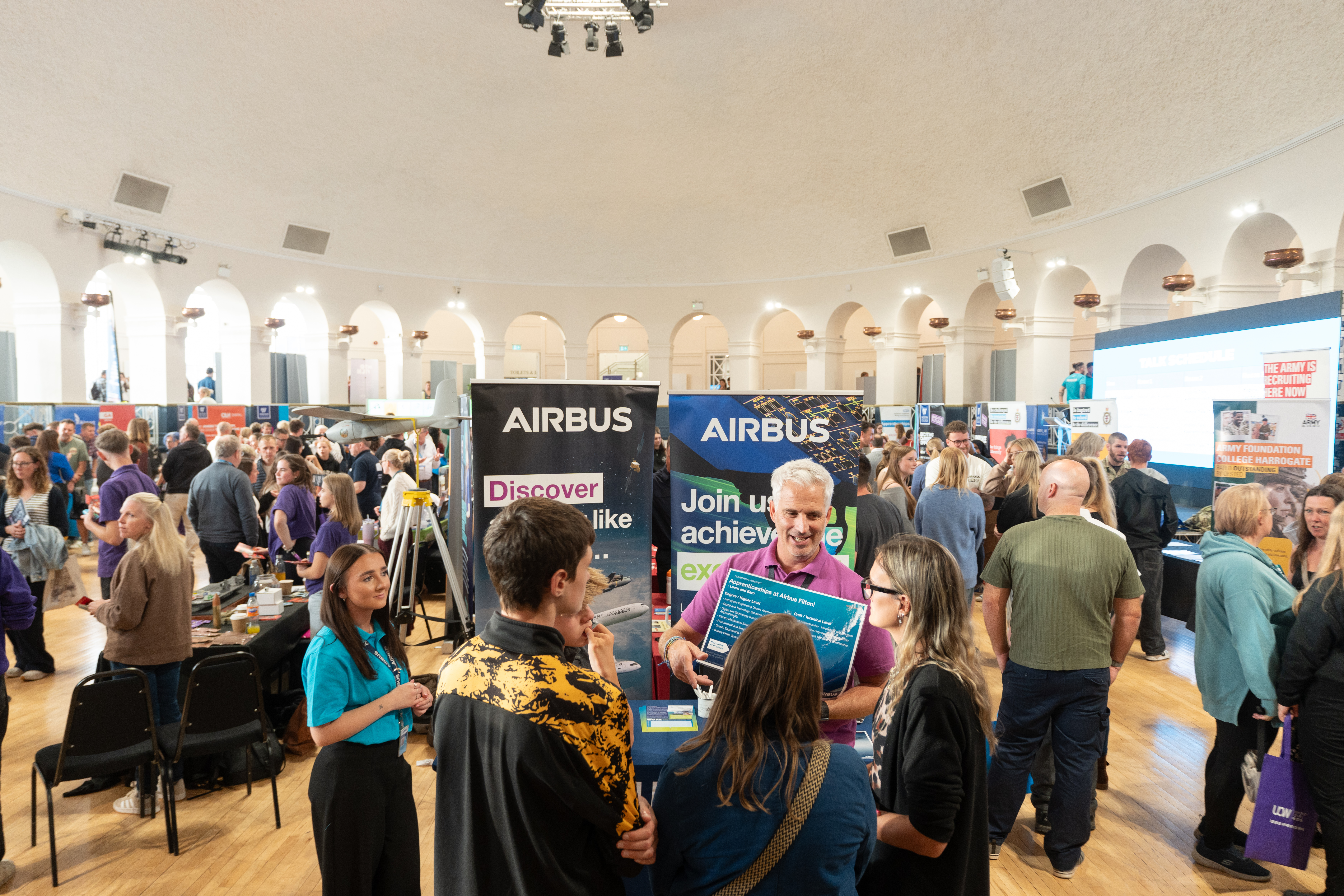 Attendees talking to employer and apprentices from Airbus