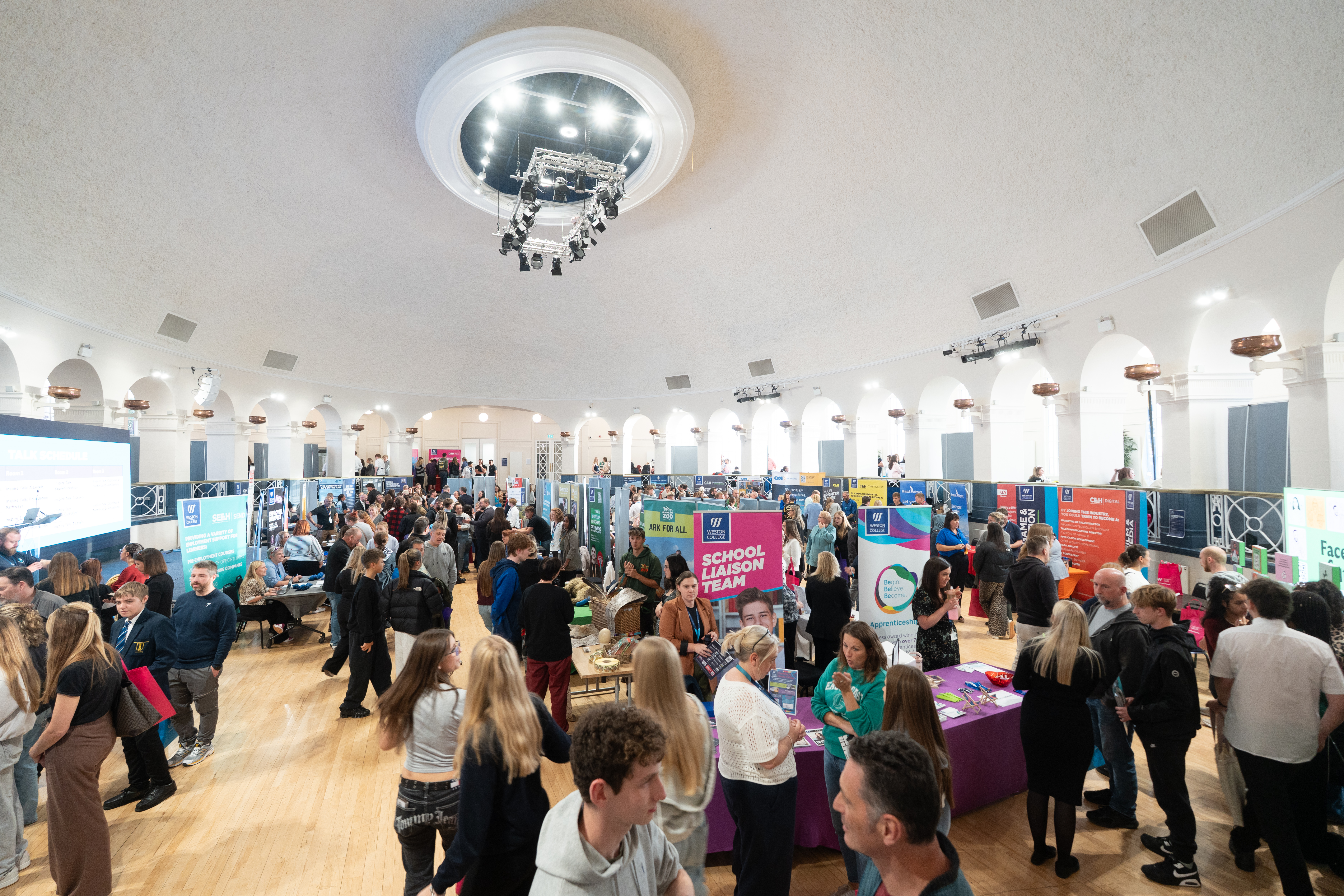 Image of ballroom with employer stands and attendees