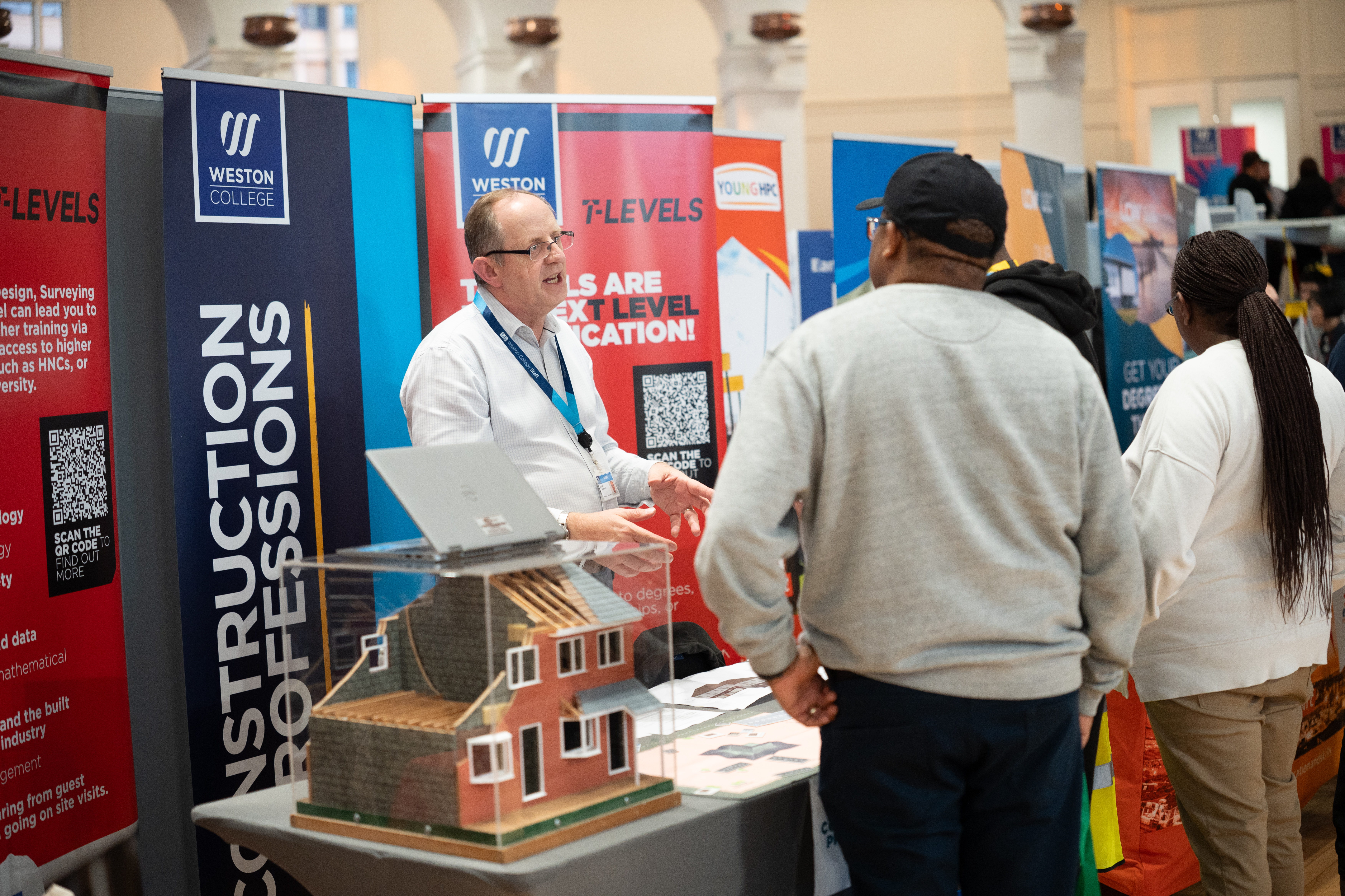 Attendees talking to Weston College Staff