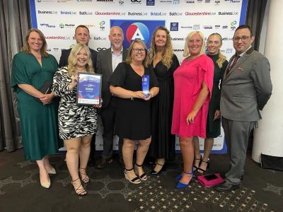Weston College staff posing with award