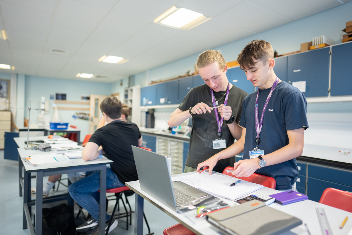 students in a science lab using measuring apparatus