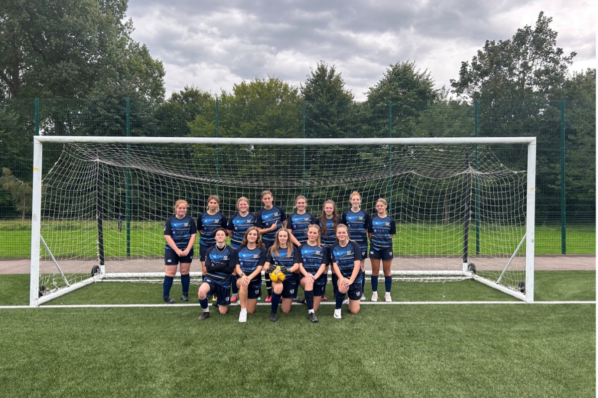 Weston sport girls football team picture on pitch in front of goal