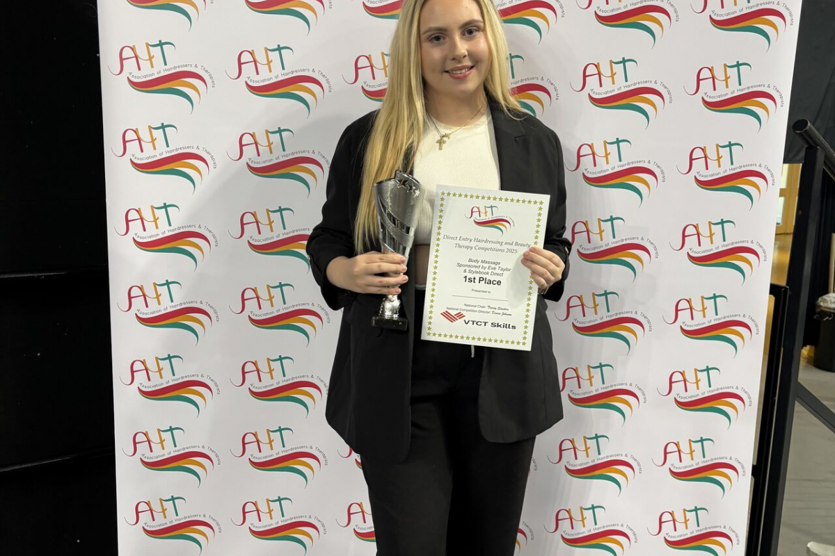 Student holding her award and certificate