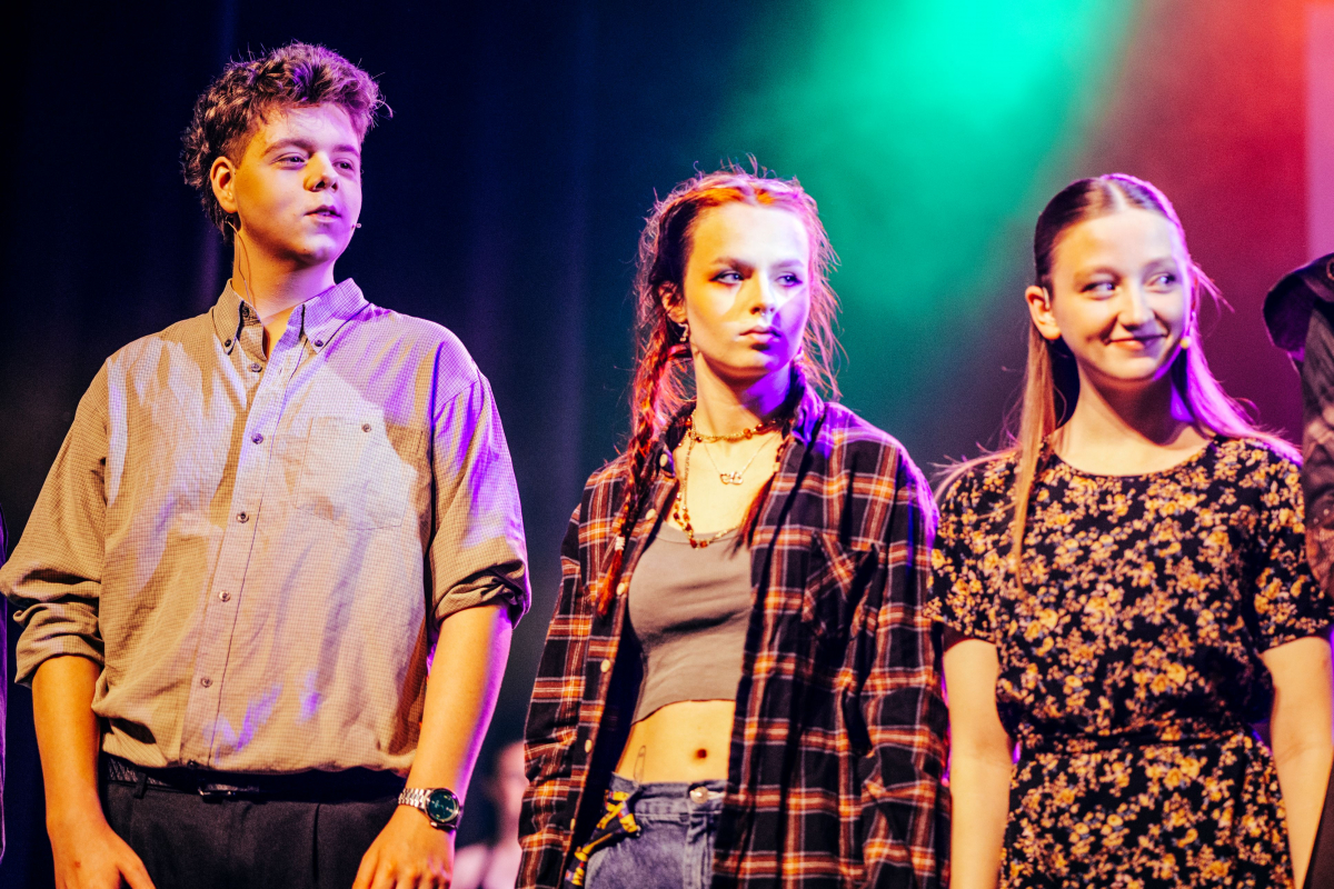 3 dreamers looking to the side from the dress rehearsal 