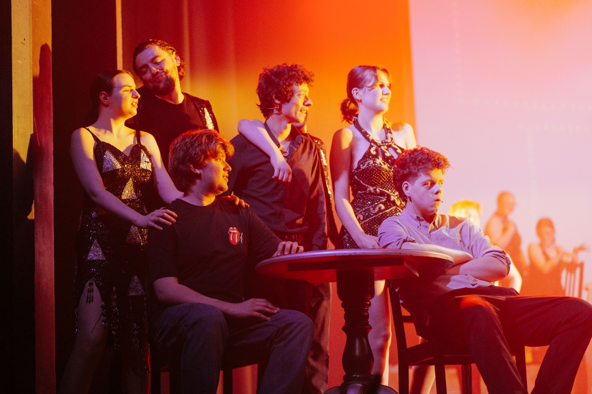 Students watching the dances from the side of the stage from the dress rehearsal 
