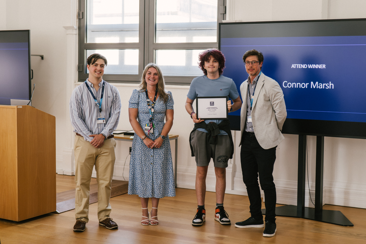 Student Holding Certificate with Staff