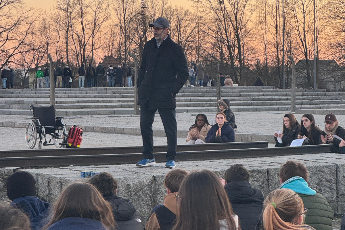 students listening to a talk at auschwitz-birkenau