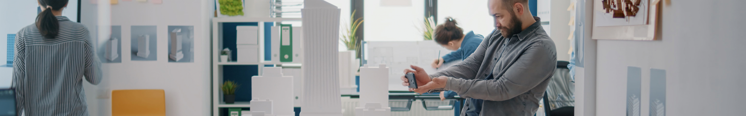Architect using phone to create blueprints