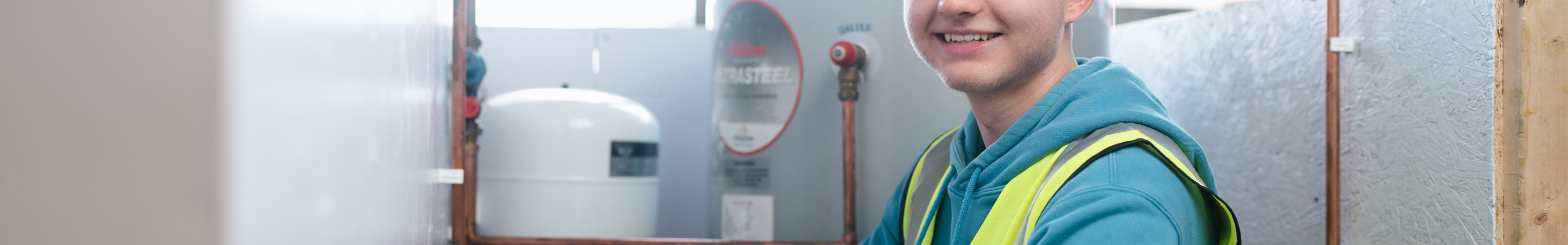 Student smiling for a photo in plumbing lesson