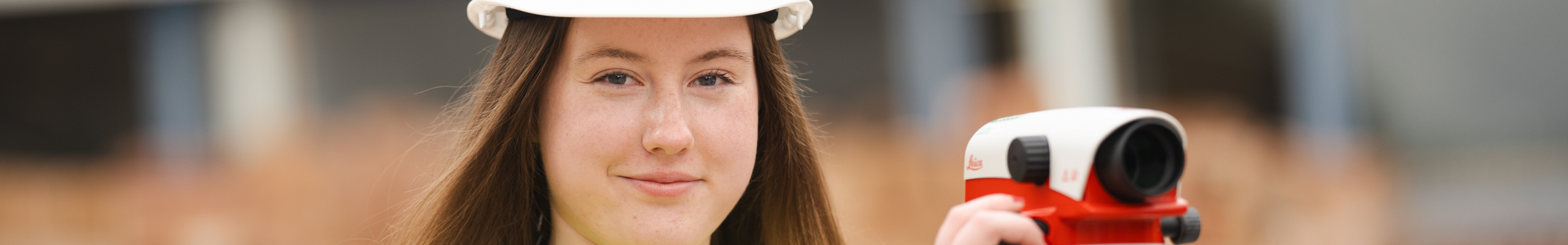 female construction student with surveyor