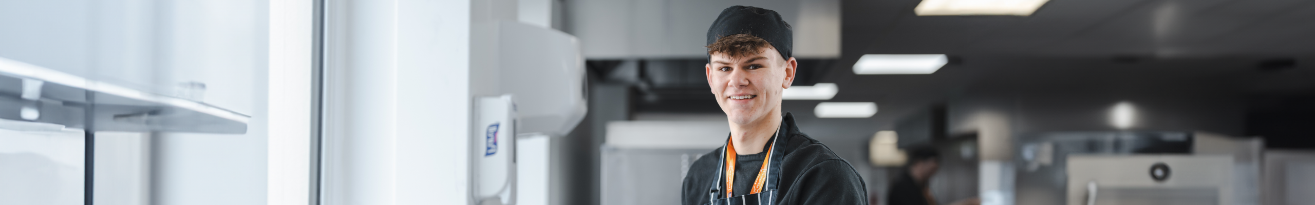 Male hospitality and catering learner in kitchen