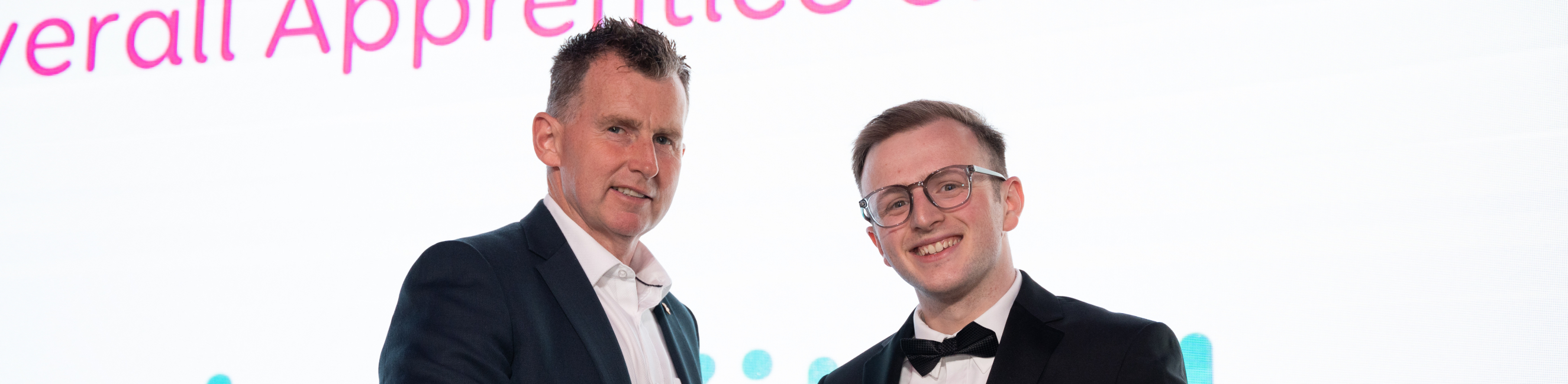 Jack Kitsell shaking hands with Nigel Owen after winning his award