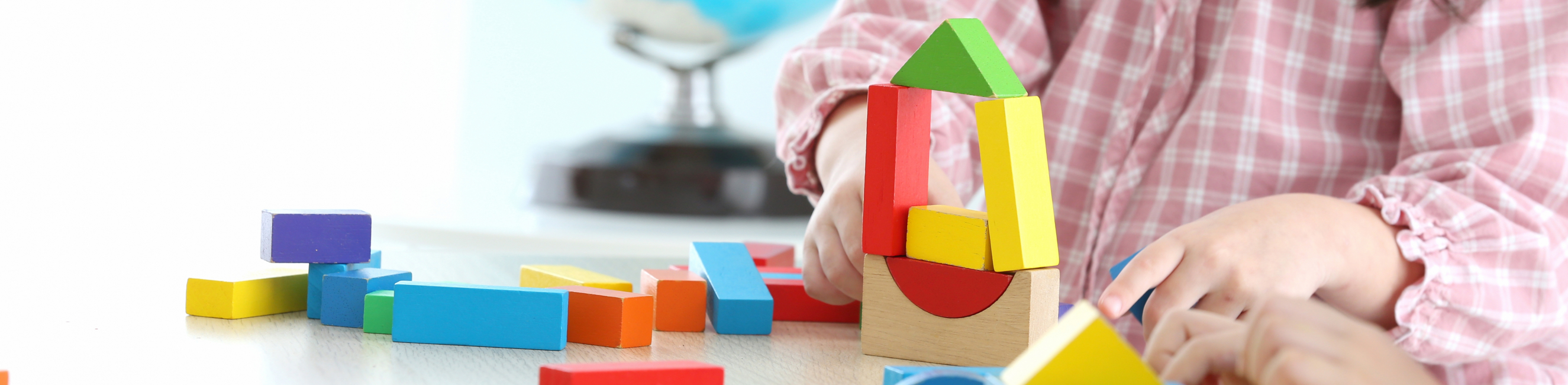 Preschool child playing with blocks