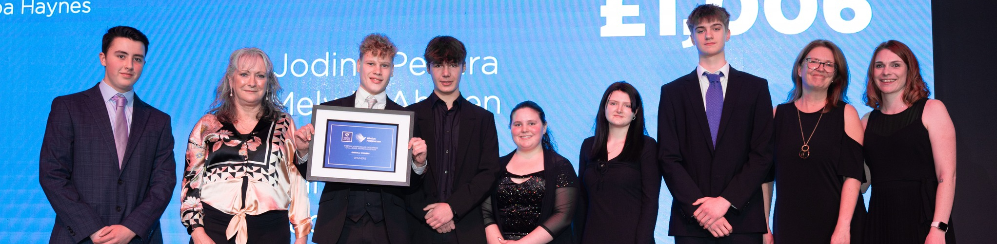 Six learners on stage receiving award for their work with Weston Hospicecare
