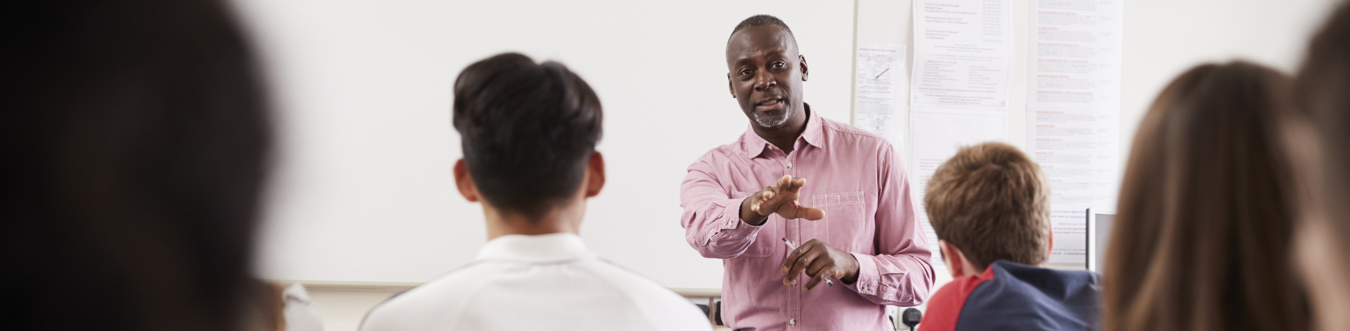 Teacher standing at front of college spanish A Level classroom