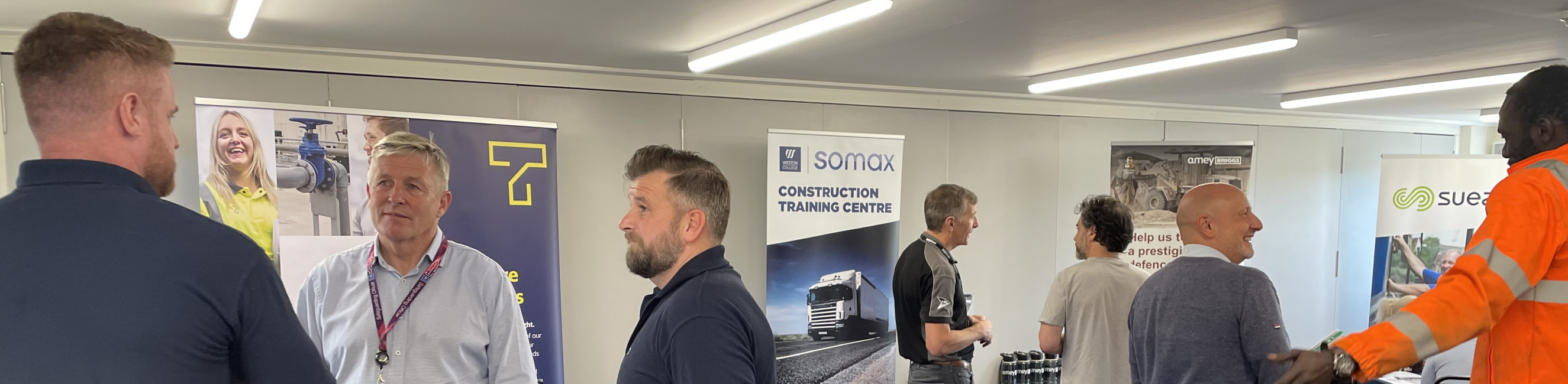 People stood chatting at the careers fair held at the Construction Training Centre