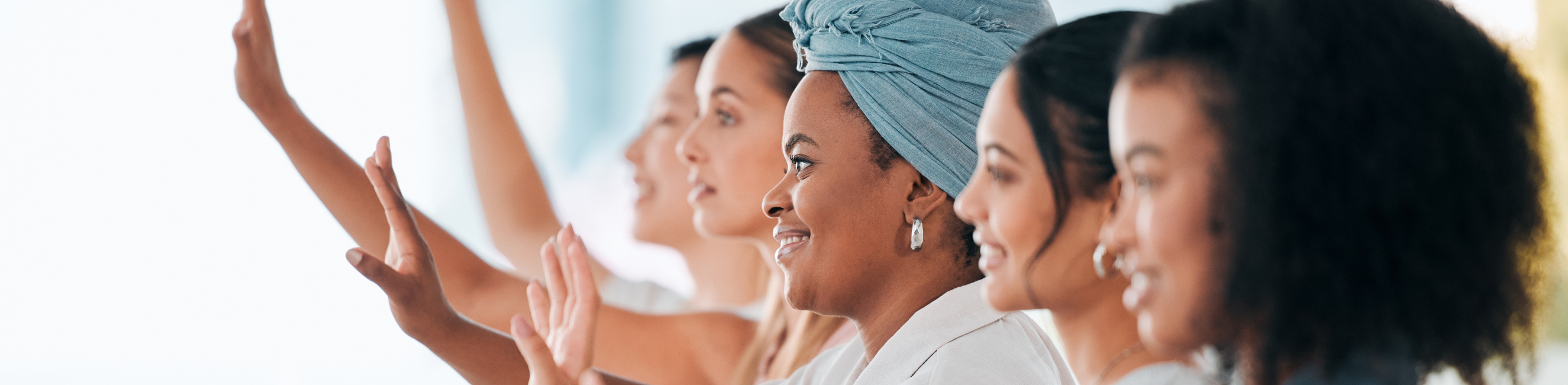 Business women with hands up in meeting