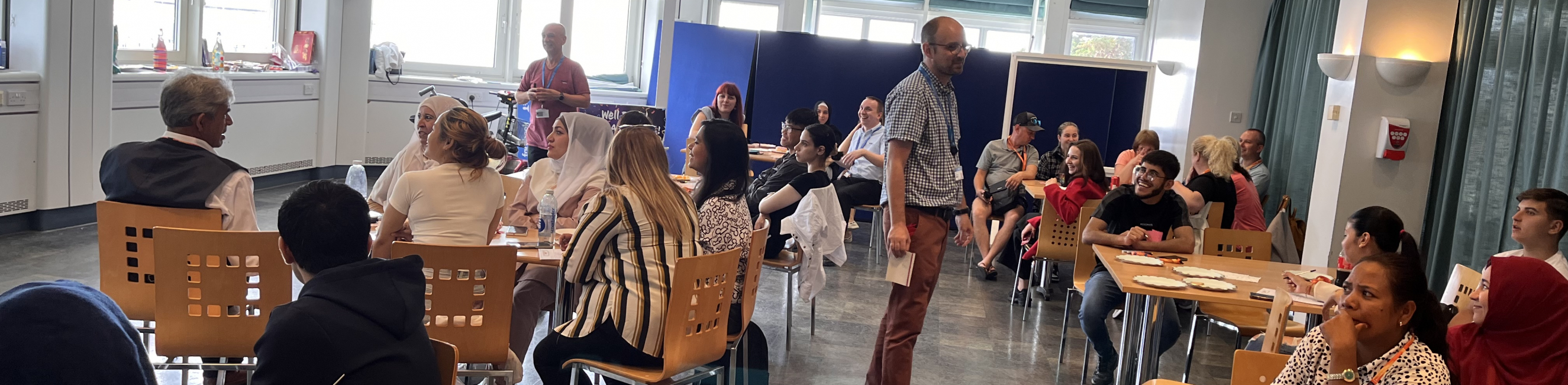 Learners sat together at ESOL celebration, whilst taking part in a quiz
