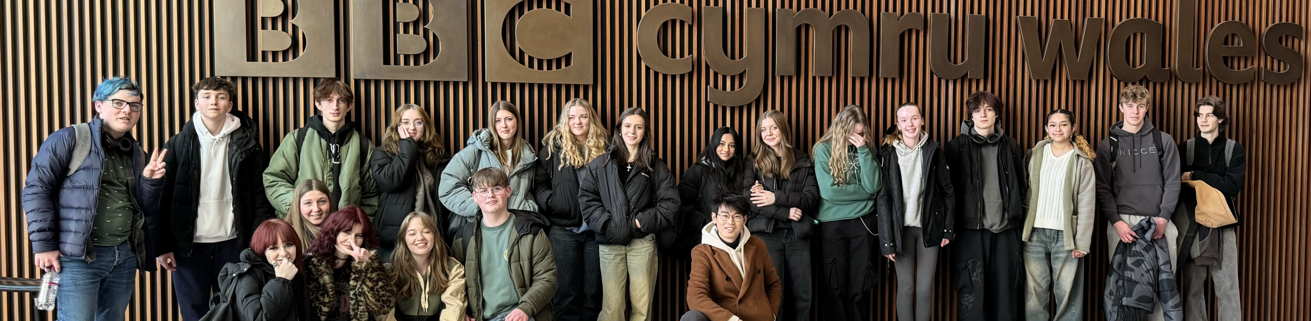 media students posed outside of the bbc wales studio headquarters