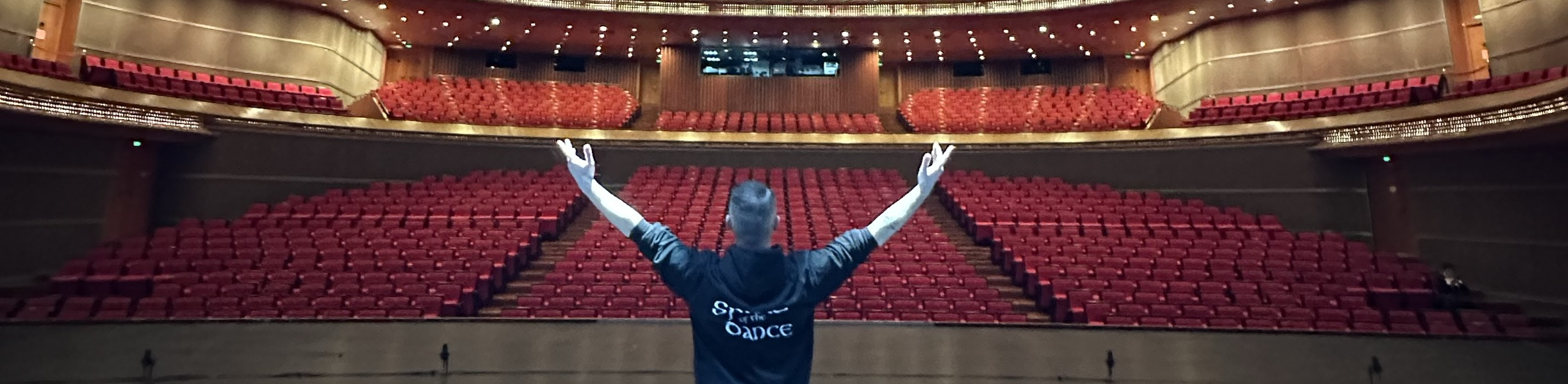 Joe, Weston College's performing arts lecturer, in Beijing, China on stage in empty theatre