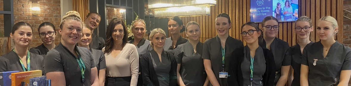 Beauty learners posing for a photo together on trip to Beauty Rooms Medi Spa