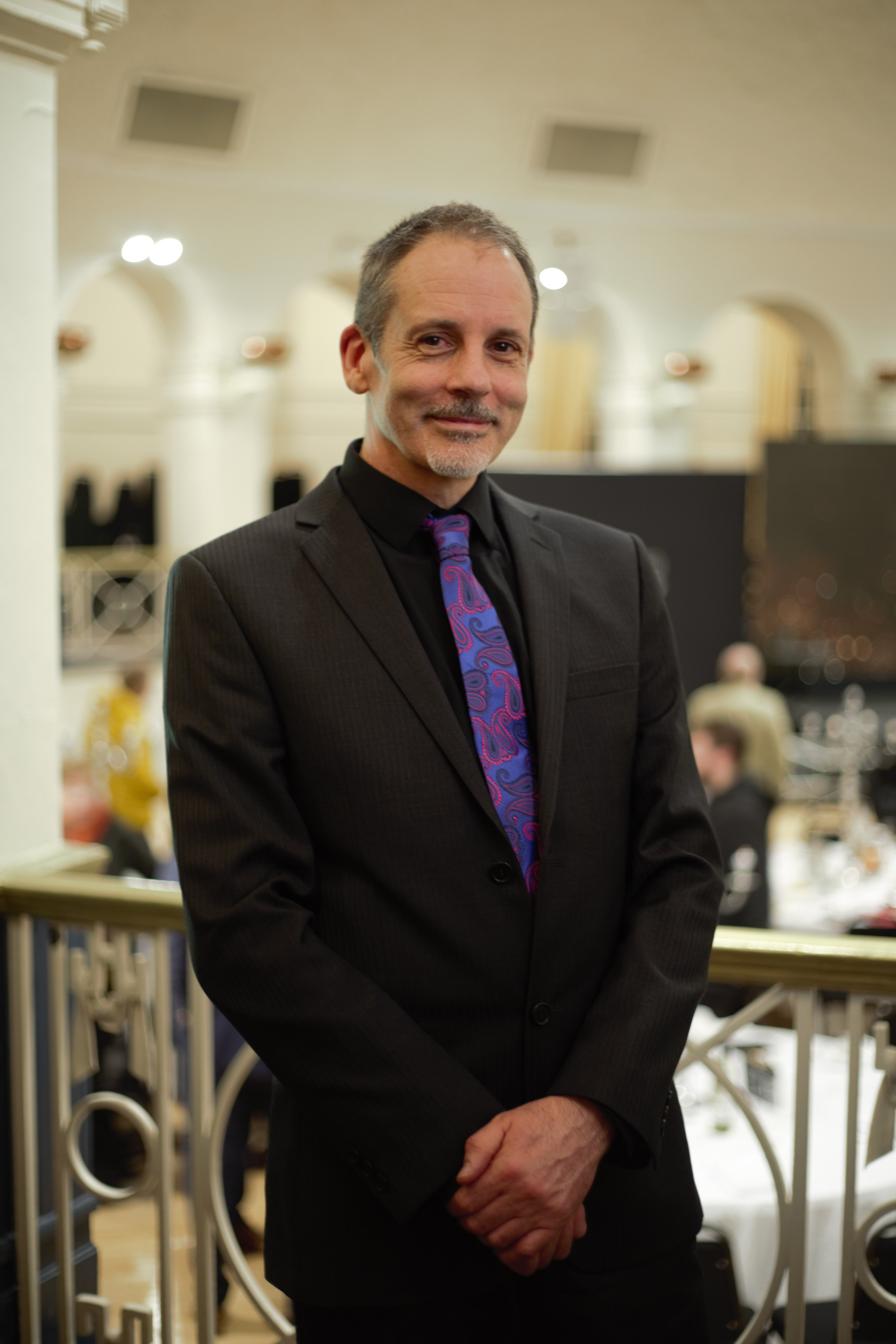 Paul French smiling at the camera at an event