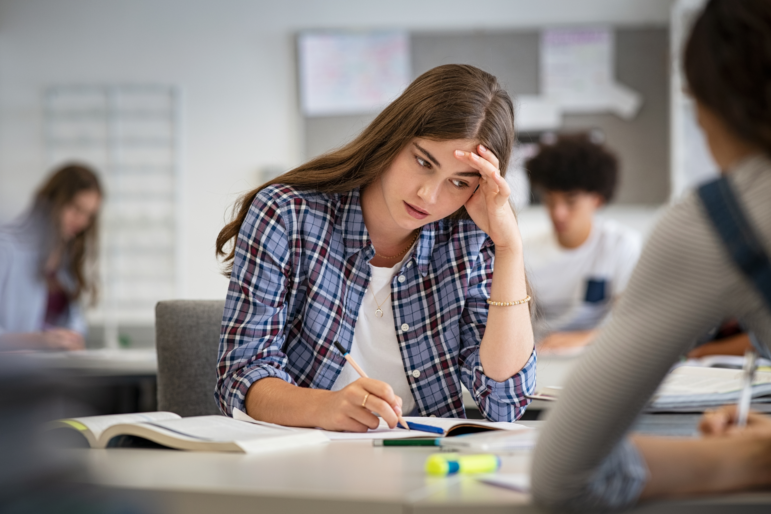Stressed female student taking an exam