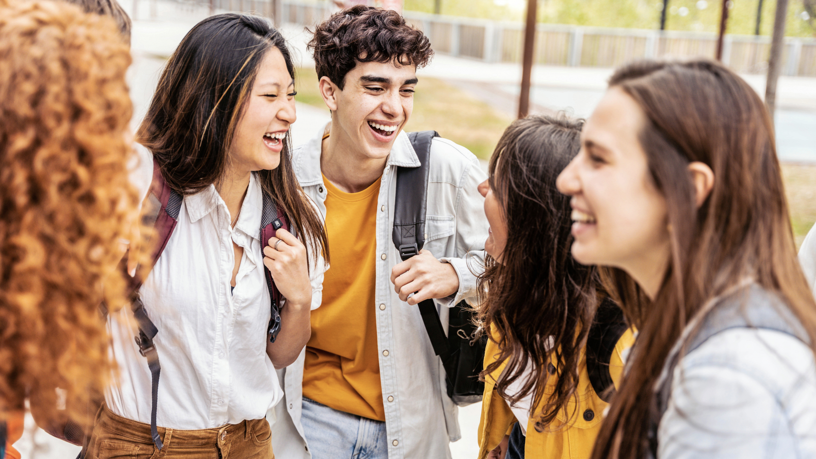 Students talking and laughing together in college campus